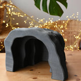 Ostheimer black wooden dragon's cave scenery piece toy placed on a wooden surface. 