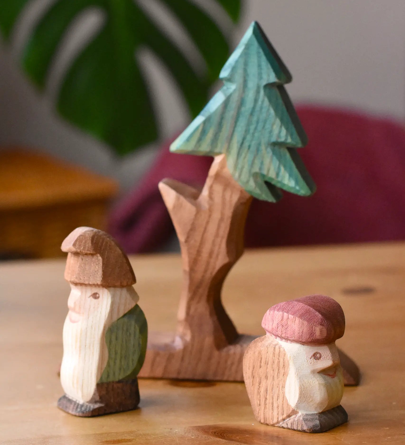 Ostheimer fir tree with dwarves wooden toy figures. The dwarves are placed in front of the tree.