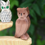 An Ostheimer brown coloured eagle owl placed on the branch of an Ostheimer bird tree. The owl figure is part of a large collection of expertly hand crafted wooden toys and figures here at Babipur. 