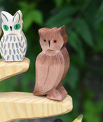 An Ostheimer brown coloured eagle owl placed on the branch of an Ostheimer bird tree. The owl figure is part of a large collection of expertly hand crafted wooden toys and figures here at Babipur. 