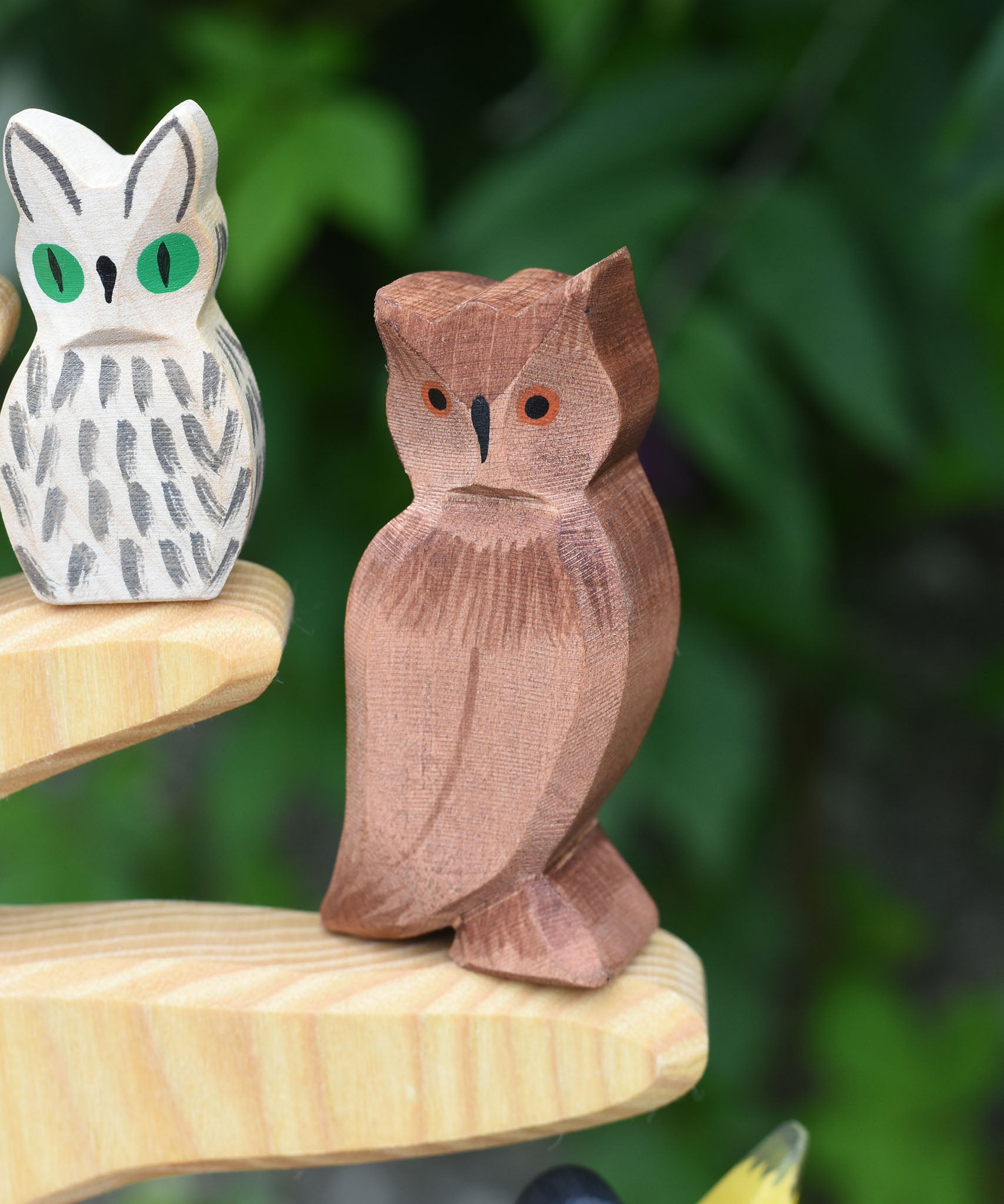 An Ostheimer brown coloured eagle owl placed on the branch of an Ostheimer bird tree. The owl figure is part of a large collection of expertly hand crafted wooden toys and figures here at Babipur. 