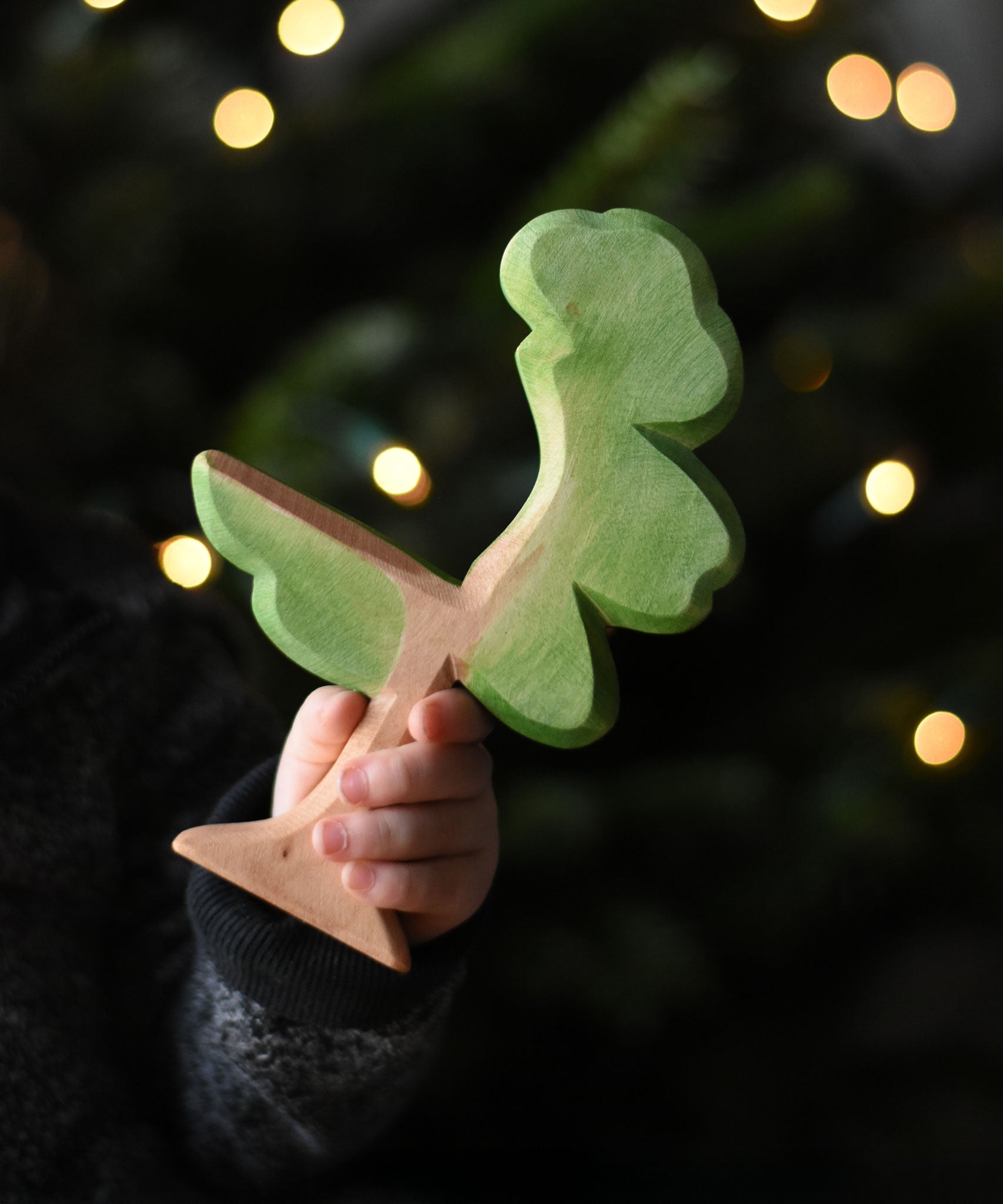 A close up of a child's hand holding an Ostheimer eucalyptus tree wooden toy figure. These wooden figures are part of a wide range of expertly hand crafted wooden toys here at Babipur. 