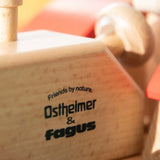 Close-up of the Ostheimer and Fagus Friends by Nature logo printed on the sustainable beech wooden tractor body.