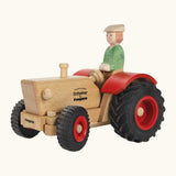 Ostheimer and Fagus collaboration handcrafted wooden traditional tractor with black wheels, red rims and mud guards with wooden farmer driving