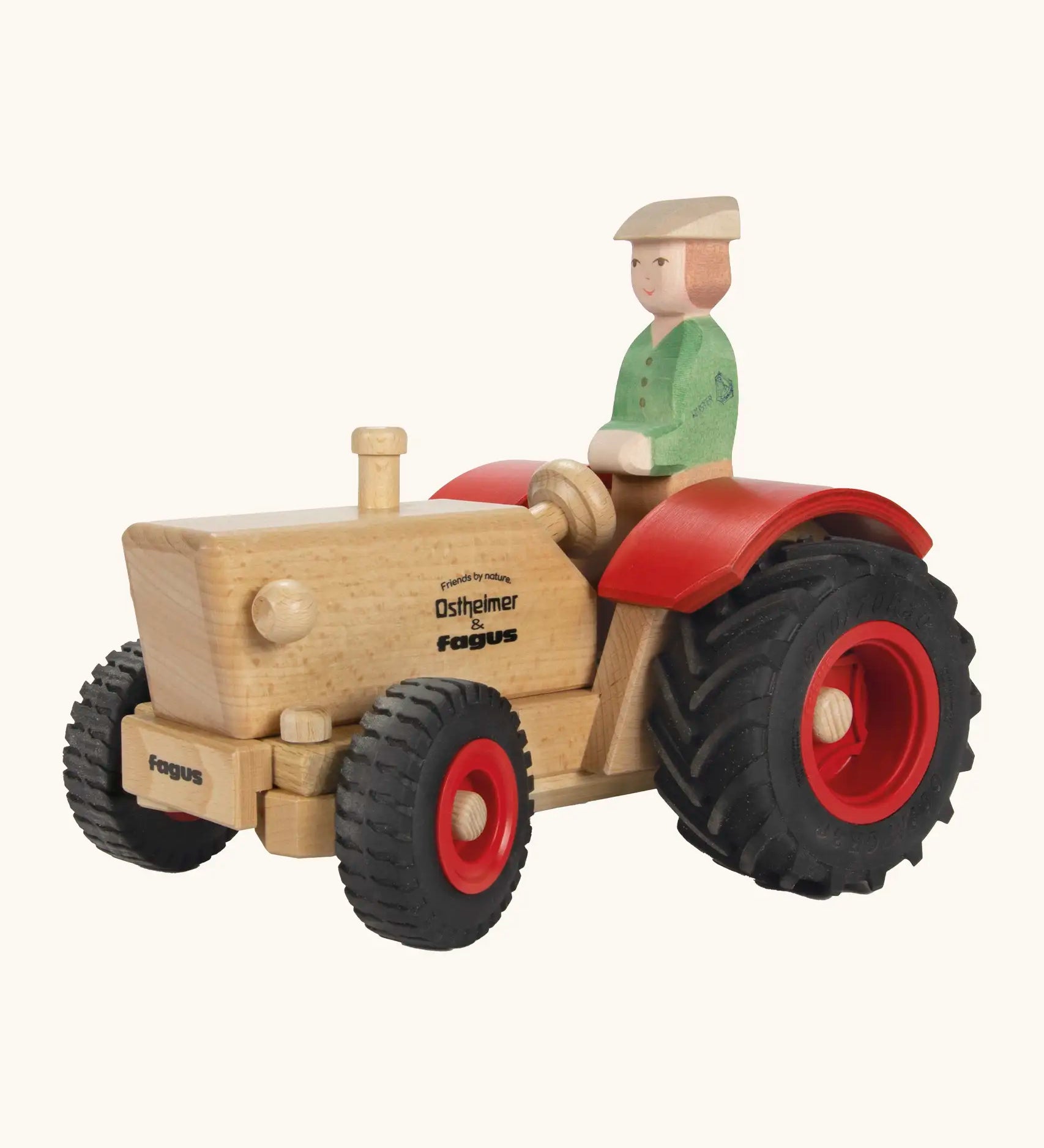 Ostheimer and Fagus collaboration handcrafted wooden traditional tractor with black wheels, red rims and mud guards with wooden farmer driving
