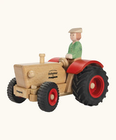 Ostheimer and Fagus collaboration handcrafted wooden traditional tractor with black wheels, red rims and mud guards with wooden farmer driving