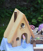An Ostheimer fairy tale dolls house with a medieval princess stood in the door way and a cat on the bird perch.
These wooden figures are part of a large range of expertly hand crafted, Waldorf inspired, wooden toys here at Babipur. 