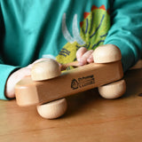 Close up of the logo on the bottom of the Ostheimer family van push along wooden toy with three people peg dolls. 
