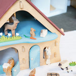 Ostheimer wooden farm house with light red roof and light blue doors