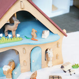 Ostheimer wooden farm house with light red roof and light blue doors