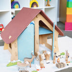 Ostheimer wooden farm house with light red roof and light blue doors