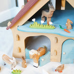 Ostheimer wooden farm house with light red roof and light blue doors