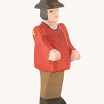 Ostheimer Farmer Man on a plain background. The wooden toy figure has movable arms and has a painted red top. 