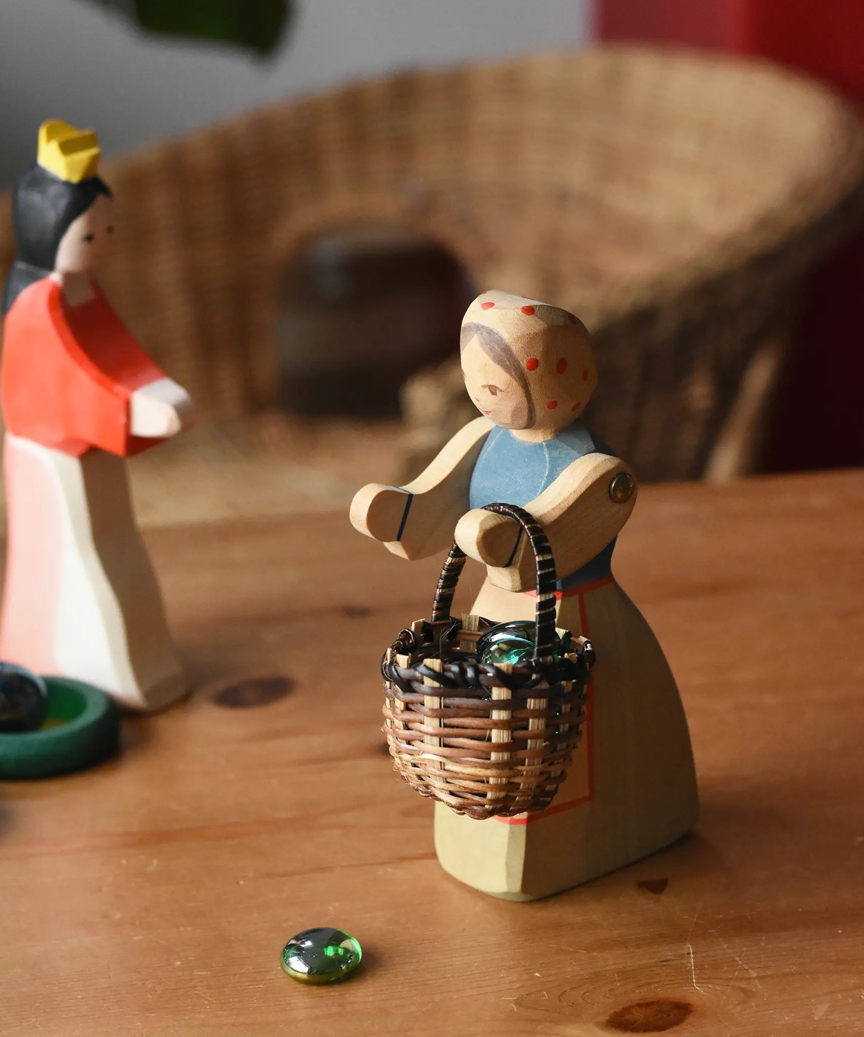 Ostheimer farmer woman wooden toy figure with a small Kraul basket filled with flay Billes marbles placed inside hung on her arms.