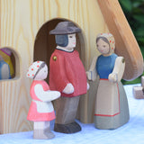 Ostheimer Heidi and male and female farmer figures placed in front of the Fairy Tale cottage. These wooden figures are part of a large range of expertly hand crafted, Waldorf inspired, wooden toys here at Babipur.