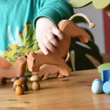 Ostheimer female lioness wooden toy figure in a child's hand in a small world play scene. 