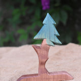 An Ostheimer wooden fir tree placed n a jute covered surface. 