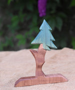 An Ostheimer wooden fir tree placed n a jute covered surface. 