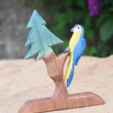 A blue Ostheimer parrot perching on an Ostheimer fir tree.