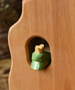 Ostheimer frog king wooden toy figure placed in a widow in the Ostheimer tower. 