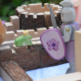 An Ostheimer fog prince wooden toy figure placed on the walls of a Magic Wood castle. The Ostheimer pink knight is standing to one side.  These wooden figures are part of a large range of expertly hand crafted wooden toys here at Babipur. 