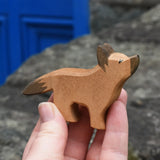 Ostheimer German shepherd wooden toy figure in an adult's hand.