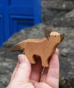 Ostheimer German shepherd wooden toy figure in an adult's hand.