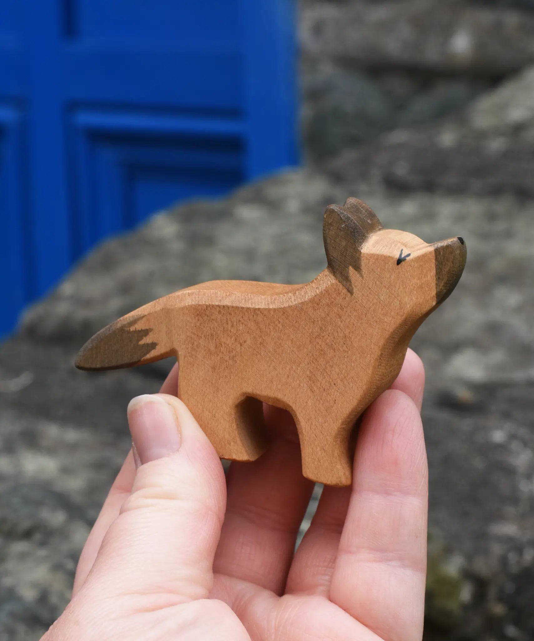 Ostheimer German shepherd wooden toy figure in an adult's hand.