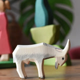 Ostheimer white goat wooden toy figure with green bush scenery pieces in the background.