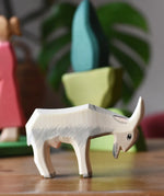 Ostheimer white goat wooden toy figure with green bush scenery pieces in the background.