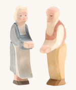 Ostheimer grandmother and grandfather wooden toy figures on a plain background. 