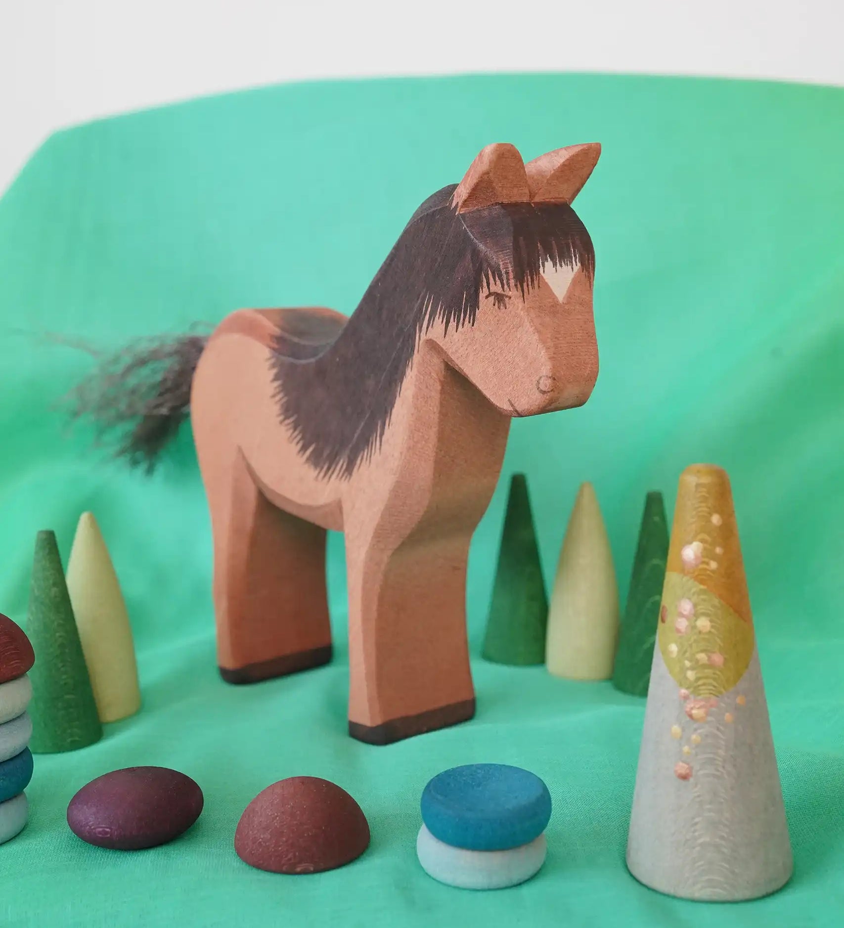 Ostheimer Iceland Horse Hrókur wooden toy figure with Grapat mandala pieces around it. 