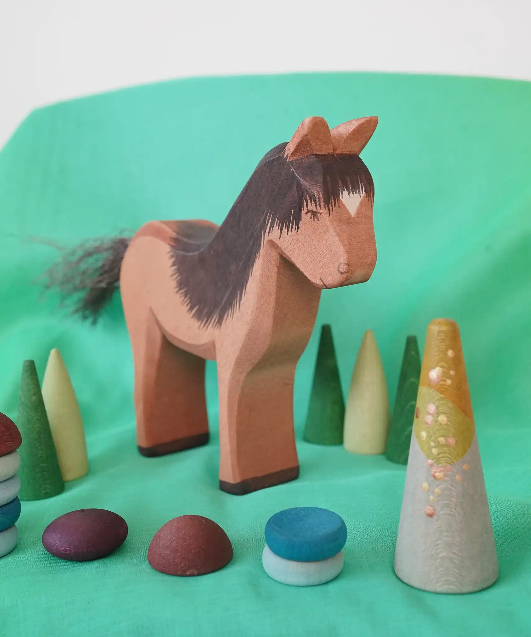 Ostheimer Iceland Horse Hrókur wooden toy figure with Grapat mandala pieces around it. 