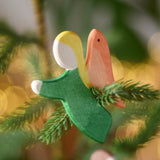 Ostheimer green angel wooden handmade decoration placed on a Christmas tree branch. 