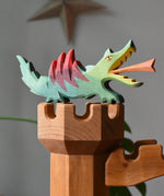Ostheimer dragon handmade wooden toy figure toy placed on top of the castle tower.