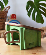 Ostheimer green hutch for toy animals placed on a wooden surface with Babipur Lanka Kade exclusive toys in the background.