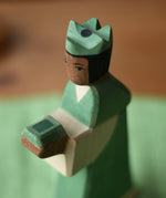 Close up of the Ostheimer green king wooden toy figure . 