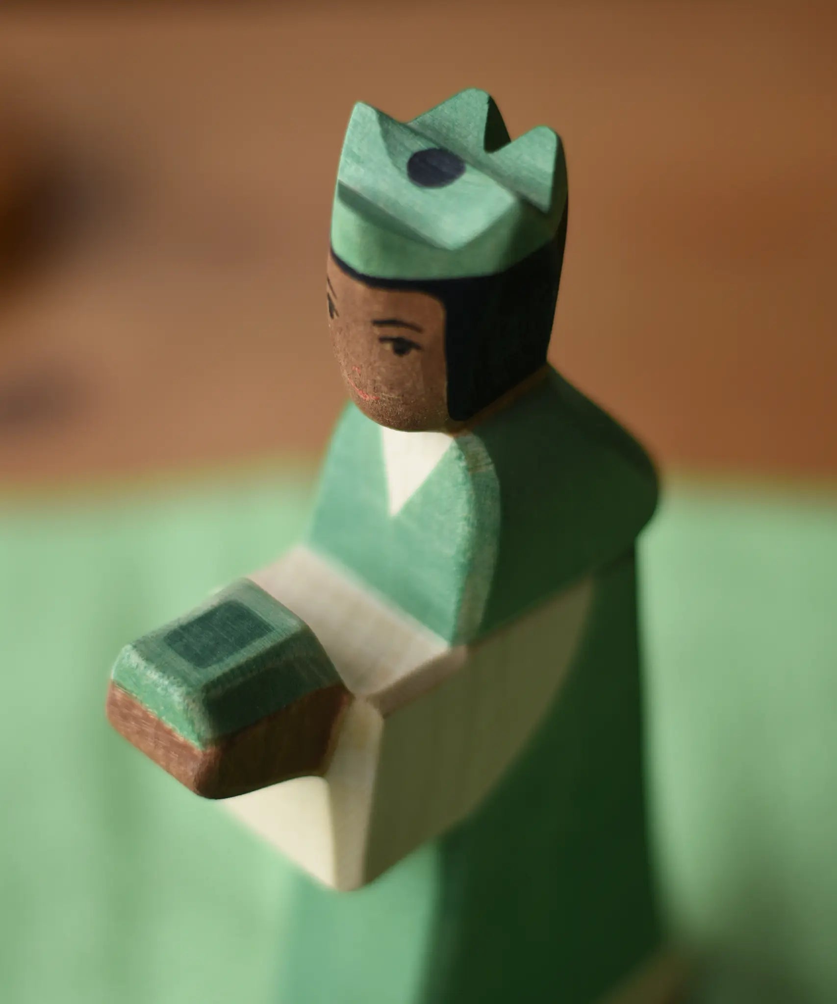 Close up of the Ostheimer green king wooden toy figure . 
