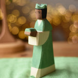 Ostheimer green king wooden toy figure placed on a cotton green play cloth. 