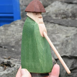 Ostheimer green shepherd with staff in an adult's hand. 