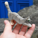 Ostheimer grey striped jumping car wooden toy figure in a child's hand.