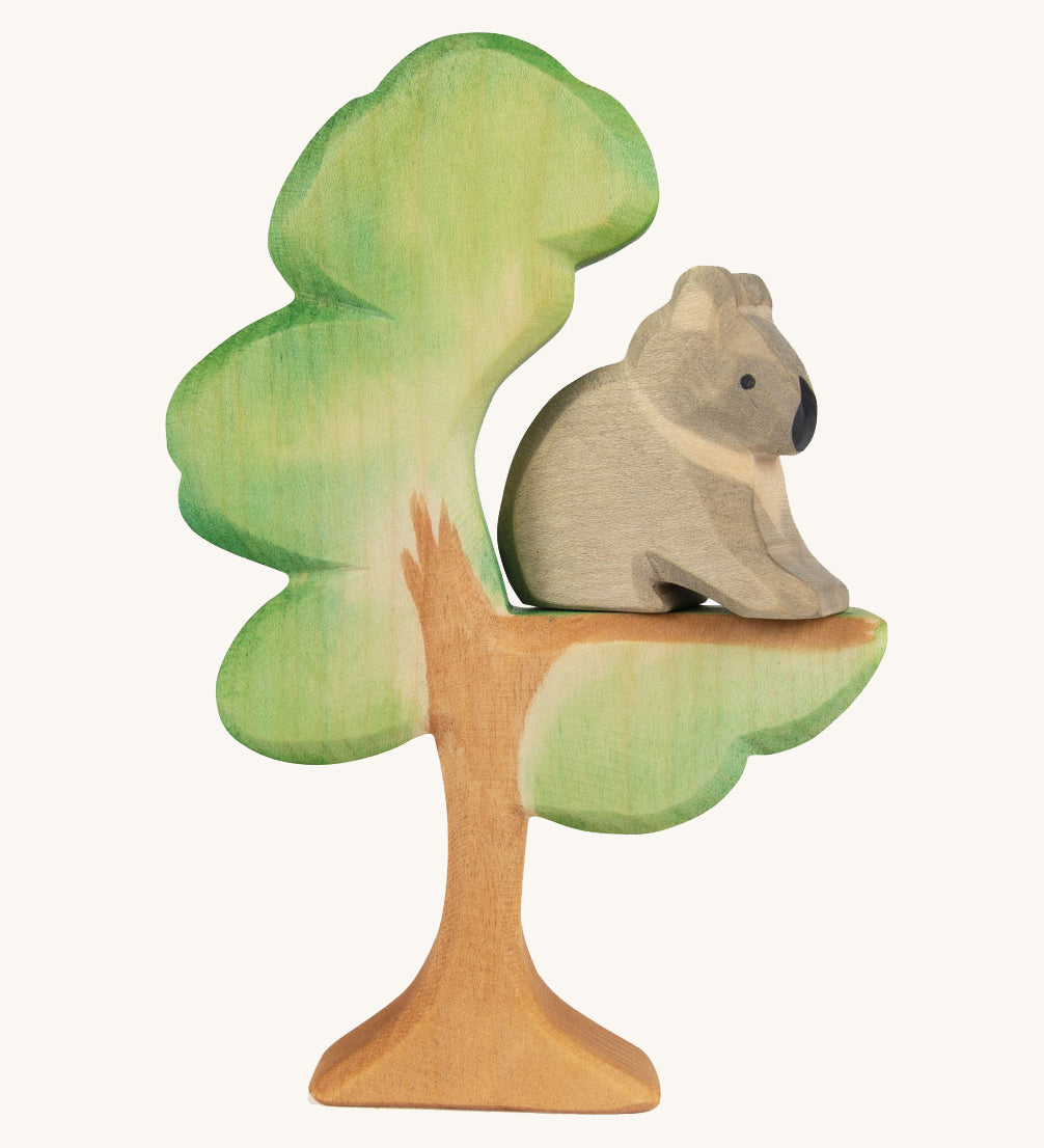 The Ostheimer hand painted and handmade wooden sitting koala figure toy, sitting on a Eucalyptus tree.