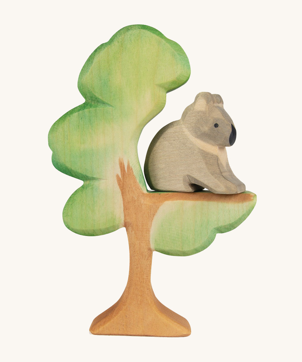 The Ostheimer hand painted and handmade wooden sitting koala figure toy, sitting on a Eucalyptus tree.
