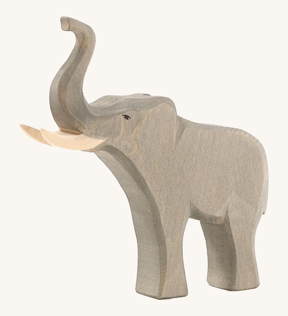 The Osheimer male elephant wooden toy, with large tusks and a trunk pointing upwards as if trumpeting.