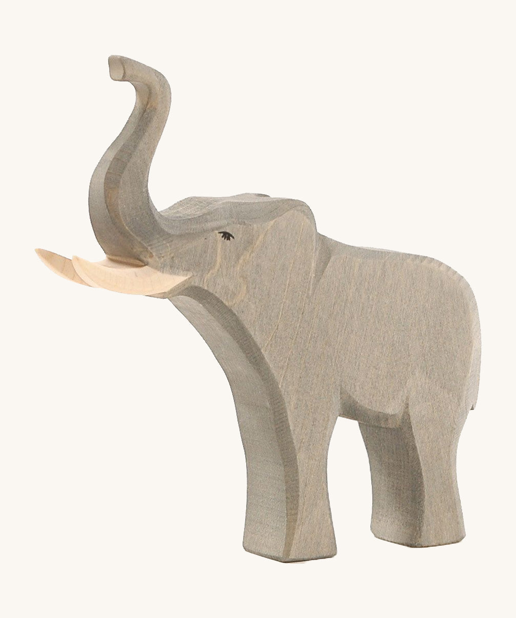 The Osheimer male elephant wooden toy, with large tusks and a trunk pointing upwards as if trumpeting.