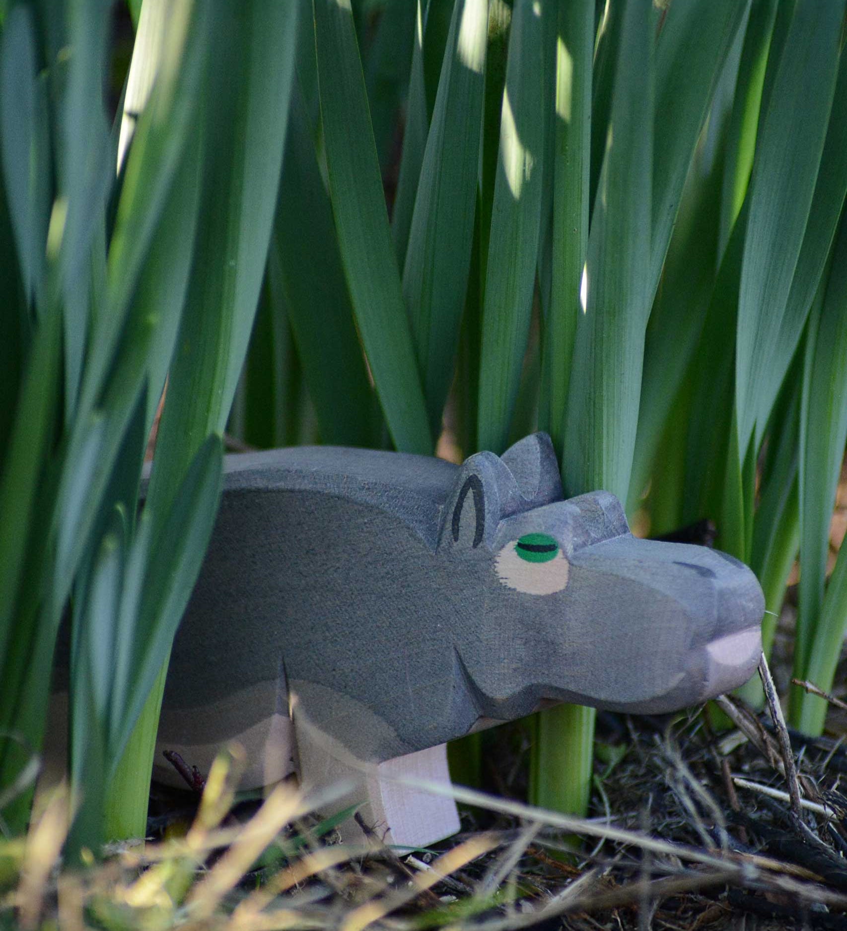 An Ostheimer hippopotamus placed among greenery outdoors. 