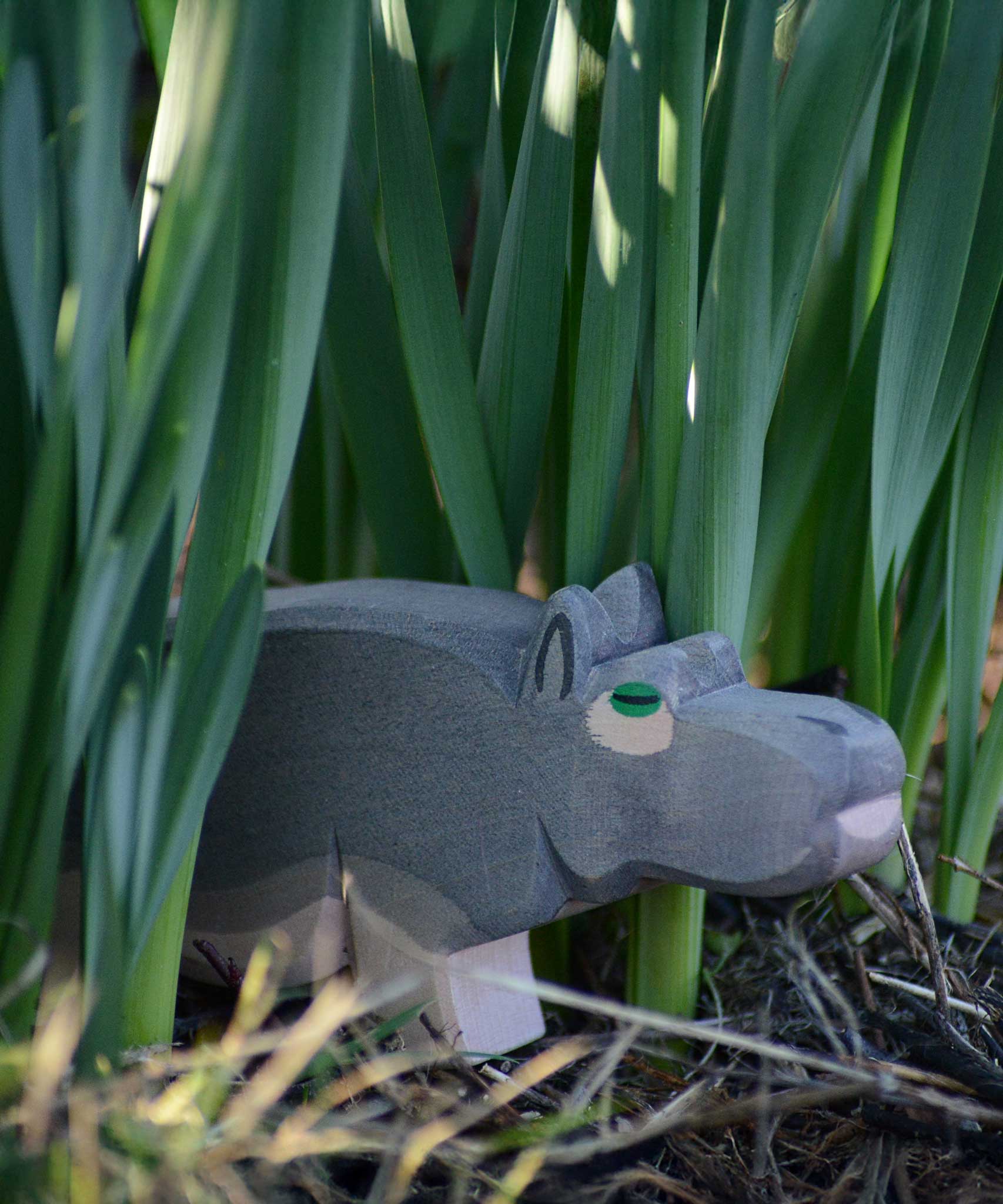 An Ostheimer hippopotamus placed among greenery outdoors. 