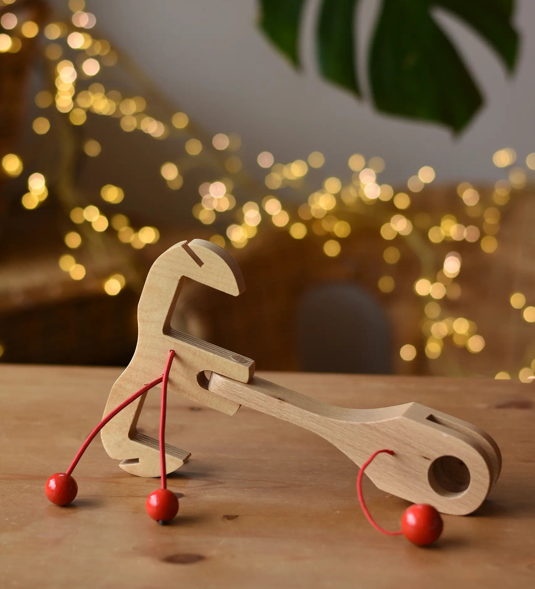 Ostheimer wooden toy horse harness accessory placed on a wooden surface. 