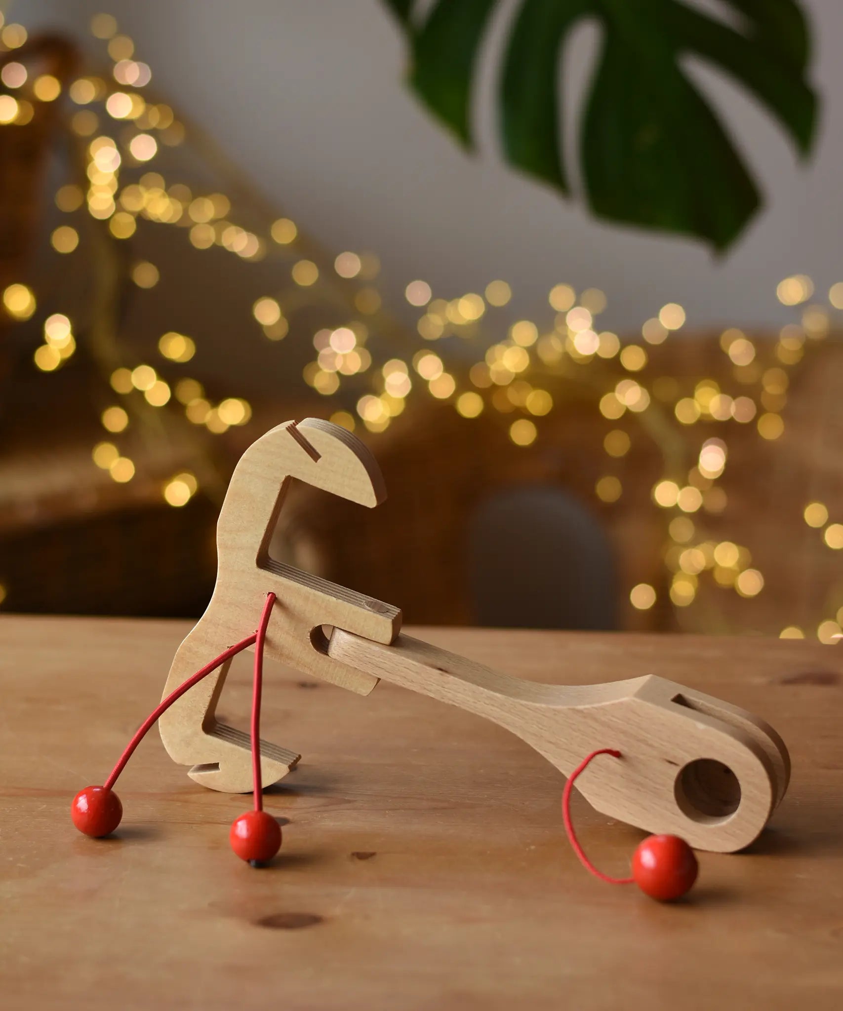 Ostheimer wooden toy horse harness accessory placed on a wooden surface. 