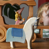 Ostheimer wooden white horse with saddle placed in front of the stage coach.